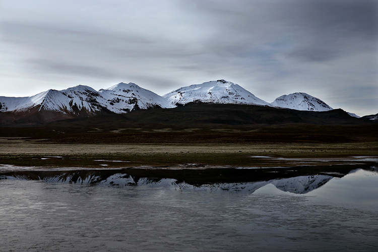 Snow capped mountain reflections, crossing from Chile into Bolivia at 4600m