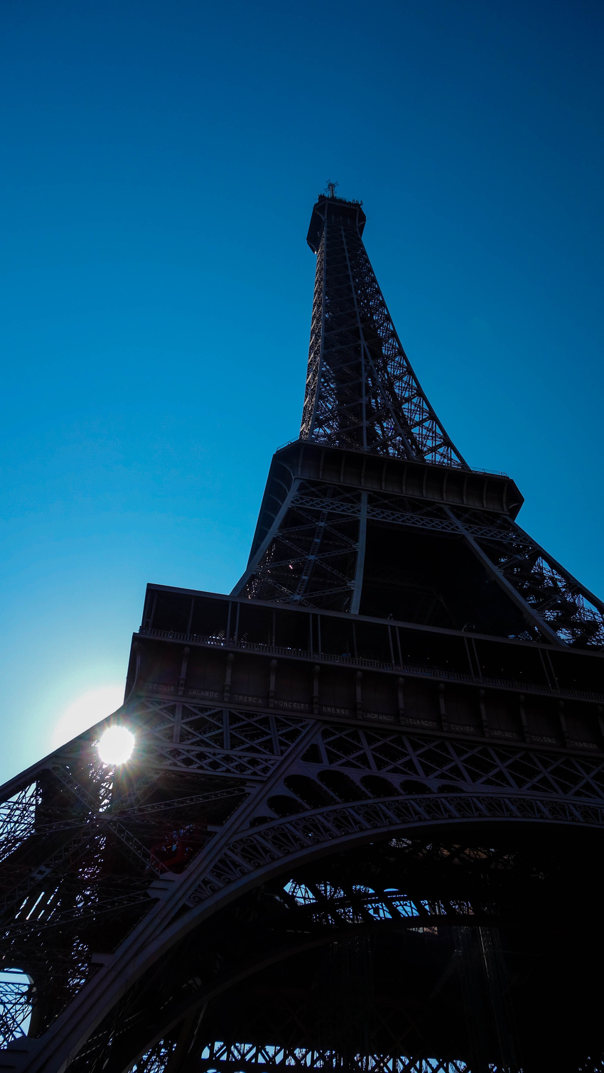 Sun Shines through the Eiffel Tower in Paris