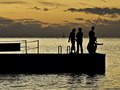 Enjoying the sunset as a family fishes. Island of Cres, Croatia.
