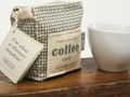 A coffee package unfolds into a dinner napkin.