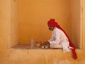 An Indian man uses his bare hands to consume a simple homemade lunch consisting of naan and water in Jaipur, India.