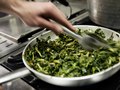 Cooking the wild leaves - La Taverna, Castellucio