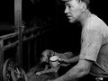 James Hamann relaxes in the near pitch dark on the front porch of his home before heading to work, near Preston Minnesota.