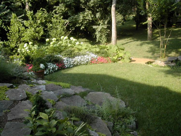 Annabelle hydrangeas, perennials and boxwoods surround the lawn.