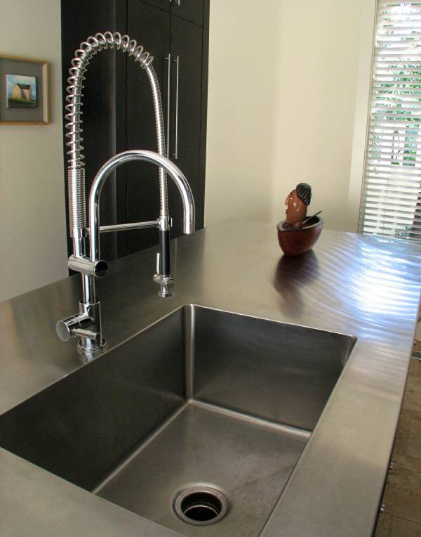 The stainless top and sink on the island are integral.