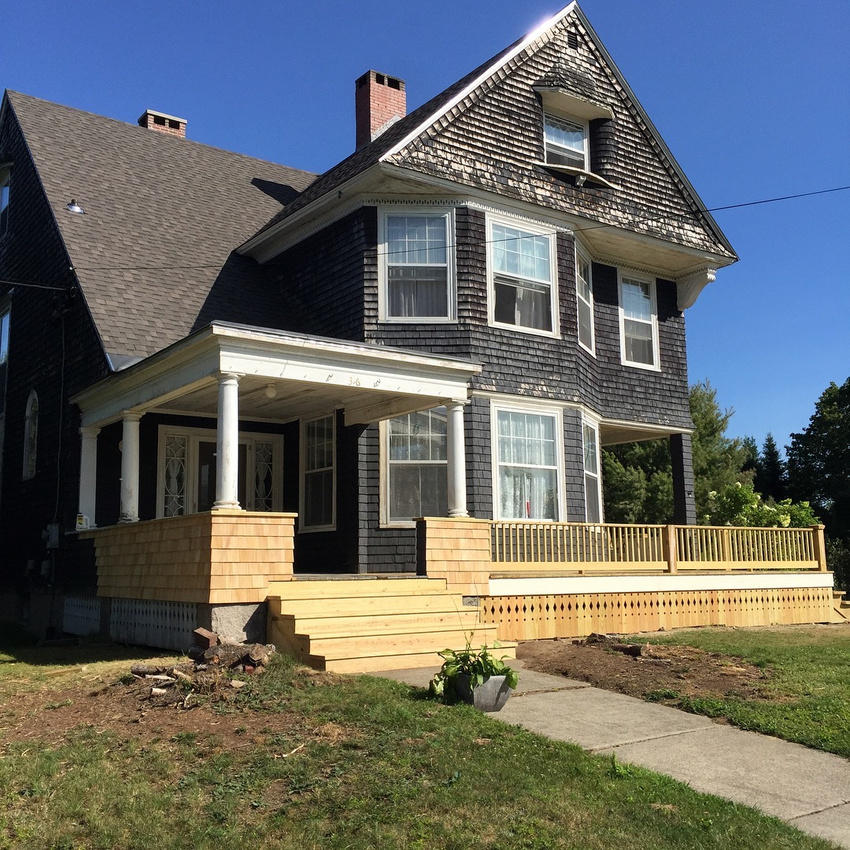 The porch spanning the front of the house was rebuilt to match the 1905 photo.